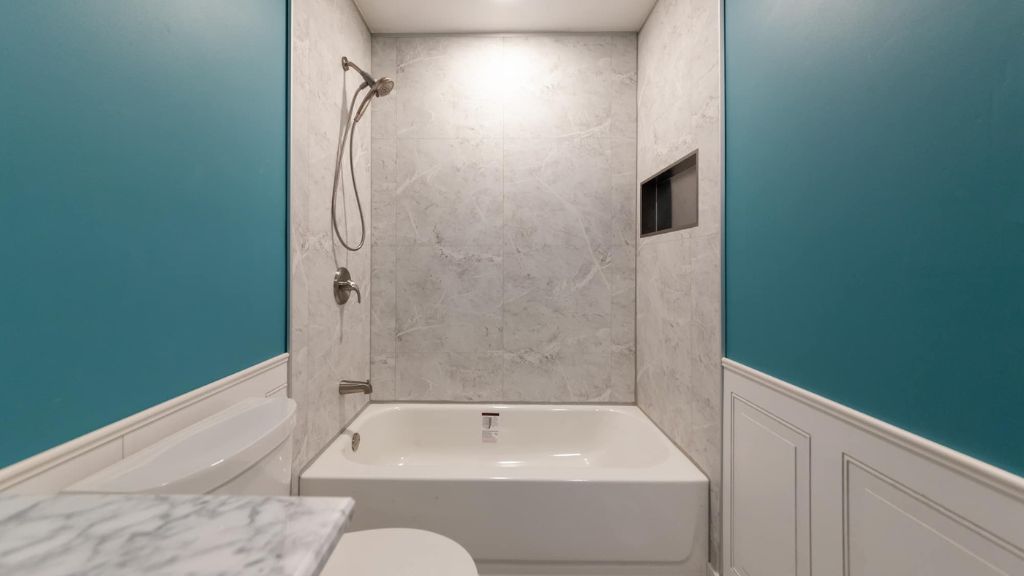 Marble effect fibo wall panel installed above a bath in a bathroom in Sarasota