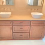 A bathroom remodel featuring a bathroom vanity with two sinks and a mirror for an enhanced bathroom design.