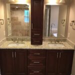 A bathroom with two sinks and a mirror, perfect for a bathroom remodel.