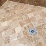 Travertine shower floor before and after.