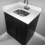 A black and white bathroom sink with a white faucet, perfect for bathroom design or remodel projects.