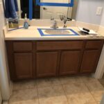 A bathroom vanity with blue tape on it, perfect for a bathroom remodel or bathroom design project.