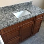 A bathroom vanity with granite counter tops is a perfect addition to your bathroom design. The sleek and sophisticated granite countertop lends an elegant touch to the overall aesthetic of your bathroom. It not only enhances the
