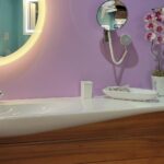 A bathroom with purple walls and a sink.