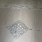 A bathroom with a tile floor and a tiled floor.