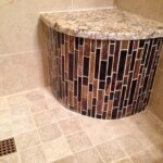 A tiled shower with a granite countertop, perfect for a bathroom remodel.