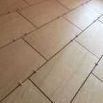 A close up view of a tiled floor in a bathroom remodel.