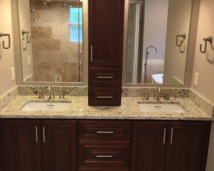 A bathroom with two sinks and a mirror, perfect for a bathroom remodel.