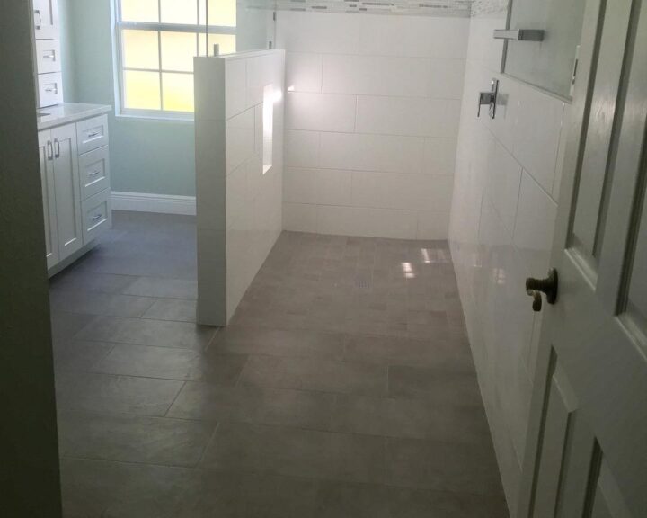 A bathroom with tile floors and a window that is perfect for bathroom design.