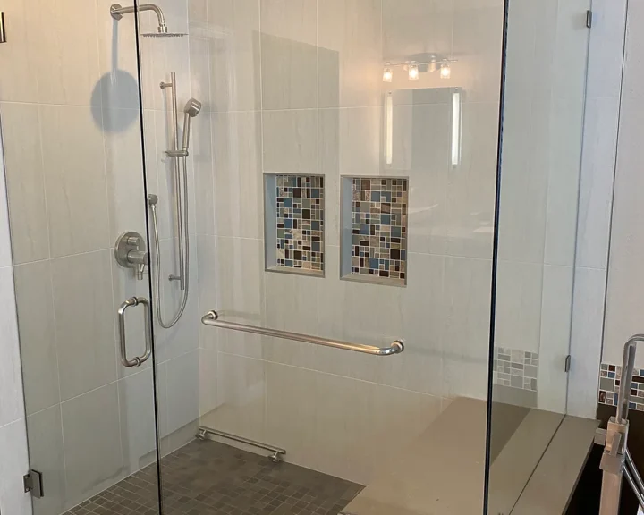 A bathroom with a glass shower enclosure, perfect for a bathroom remodel.