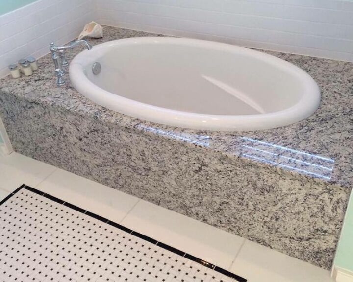 An elegant bathroom with a white tile floor and a bathtub.