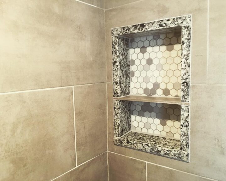 A tiled shower with a tiled shelf, perfect for your bathroom remodel and bathroom design needs.