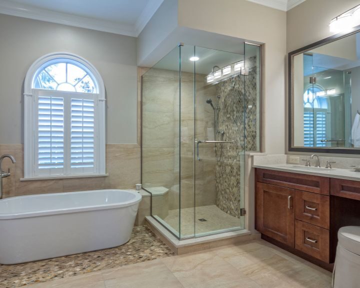 A modern bathroom featuring a glass shower and a luxurious bathtub.