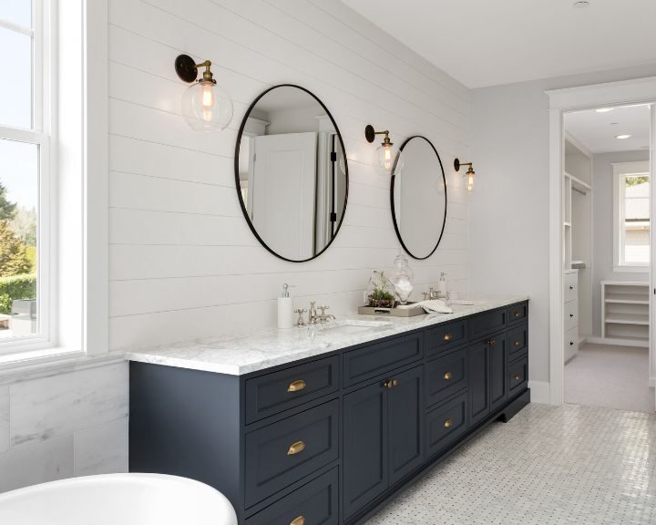 A bathroom with two sinks and a mirror on a bathroom countertop.