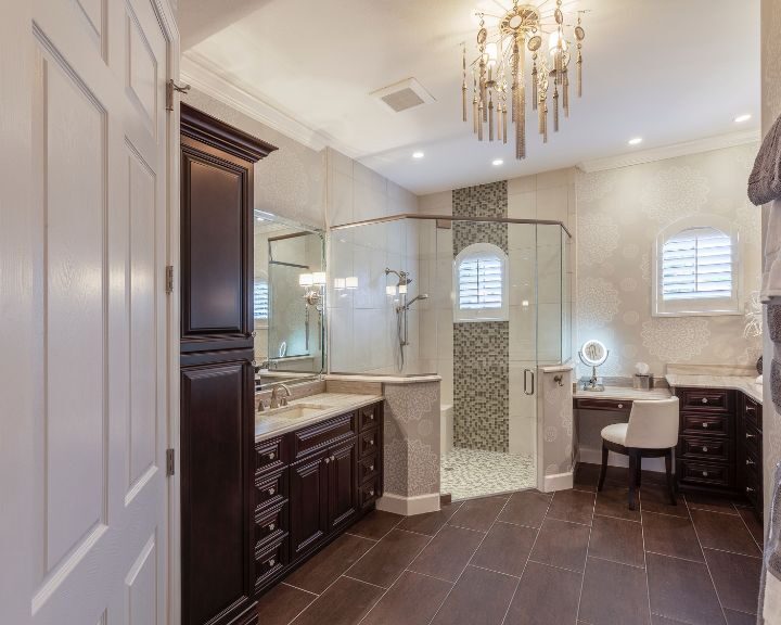 A bathroom with a large walk in shower and double sinks, featuring a modern bathroom countertop.