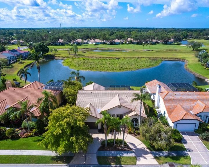 An aerial view of a home featuring a pond.