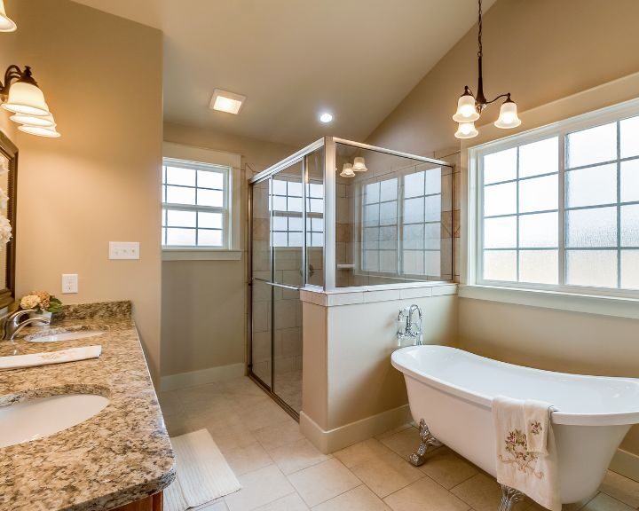 A bathroom with a bathtub, sink and shower.