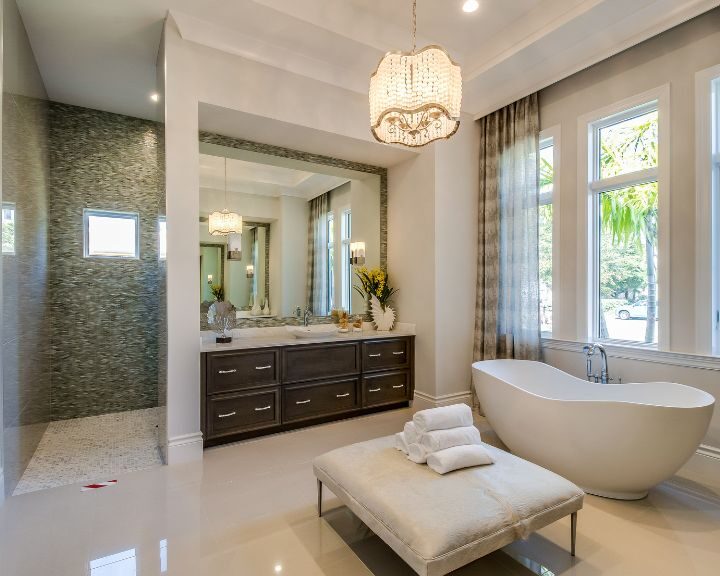 A large bathroom with a large tub and a chandelier, perfect for a luxurious bathroom remodel.