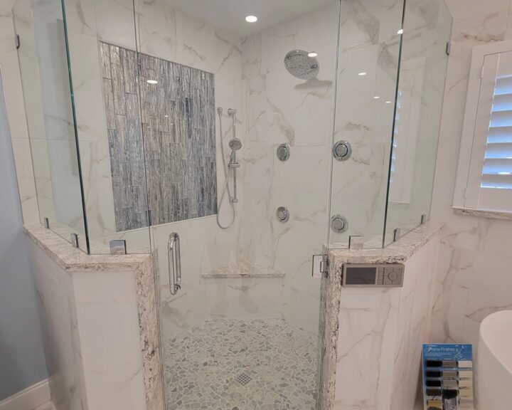 A modern bathroom with a glass shower door.