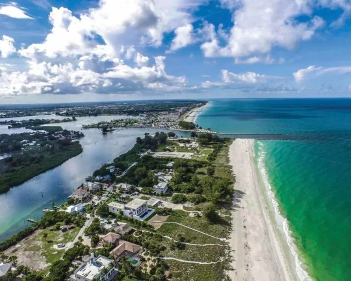 An aerial view of a beach and ocean showcasing the serene beauty of the natural environment.