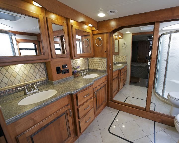 A bathroom with a toilet, sink, and mirror.