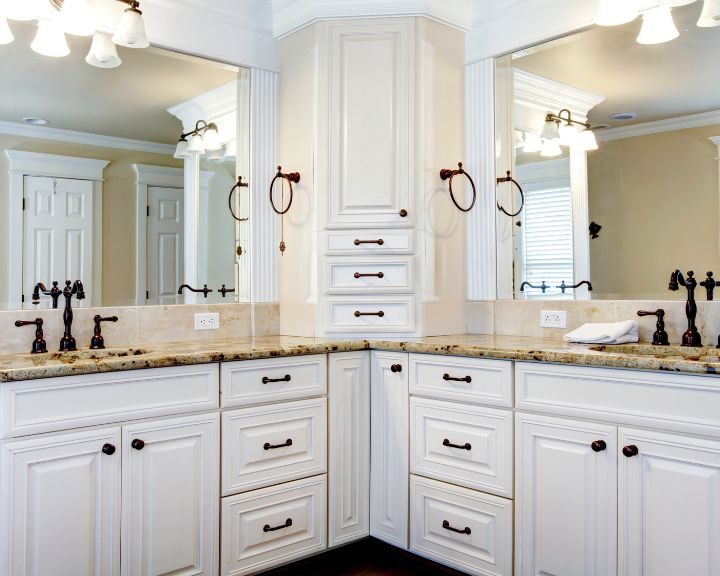 A bathroom with white cabinets and granite countertops featuring a modern bathroom design.